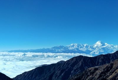 Scenic view of snowcapped mountains against clear blue sky