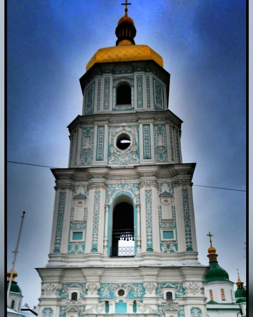 religion, spirituality, place of worship, architecture, built structure, building exterior, low angle view, statue, sky, history, day, cross, outdoors, dome, sculpture, no people, bell tower