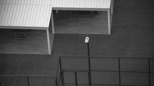 Empty chairs and table against wall in building