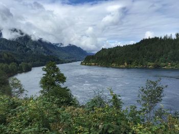 Scenic view of lake and mountains against sky