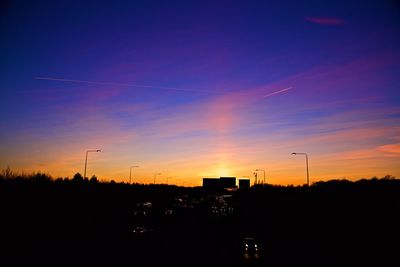 Silhouette of tower against sky at sunset