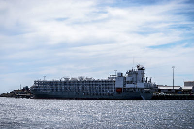 Commercial dock by sea against sky