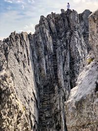 Low angle view of rock formation on mountain against sky