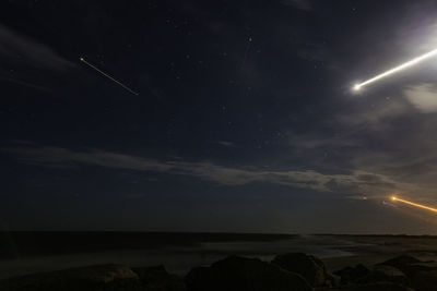 Scenic view of sea against sky at night