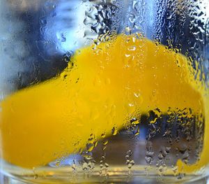 Close-up of yellow glass with water