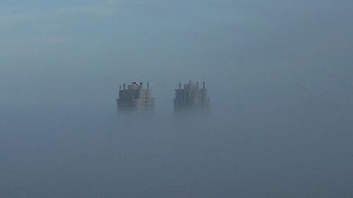 Scenic view of buildings in city against sky