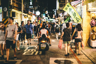 Panoramic view of city street at night