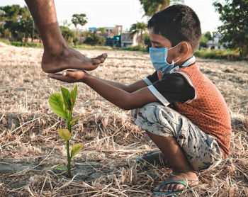 Father with baby on plant