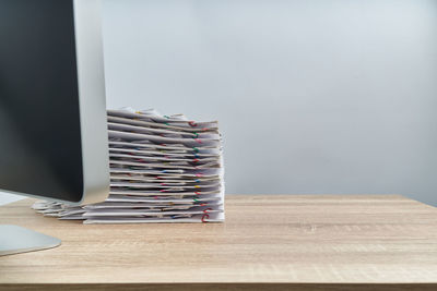 Stack of books on table against wall