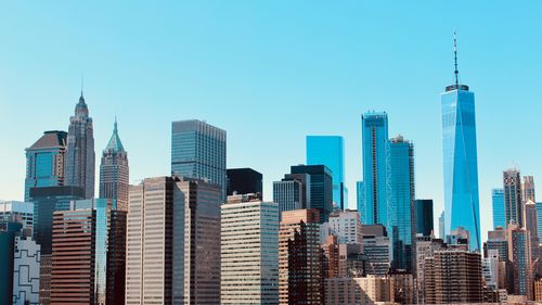 Skyscrapers of lower manhattan against blue sky