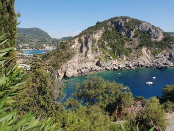 Scenic view of bay against clear blue sky