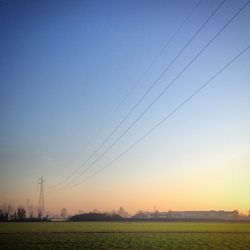 Scenic view of field against clear sky during sunset