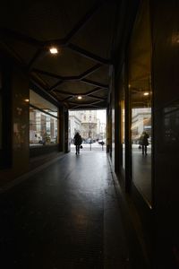 People walking in illuminated building