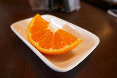 Close-up of orange slice in plate