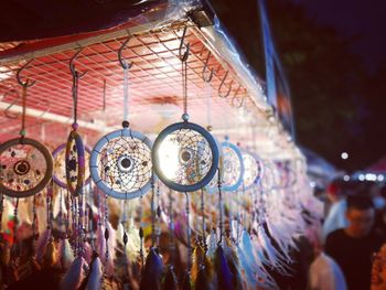 Low angle view of people at illuminated market