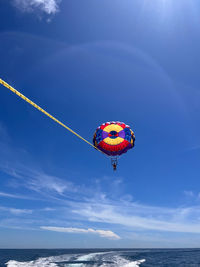 Person paragliding against sky