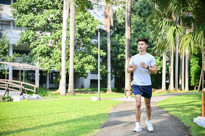 Full length of young man standing on field