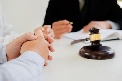 Cropped hands of man by lawyer