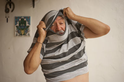 Senior man wearing t-shirt at home