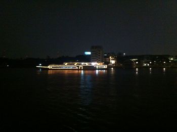 River with illuminated buildings in background