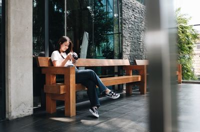 Full length of woman sitting on chair