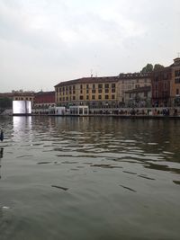 Reflection of buildings in water against sky