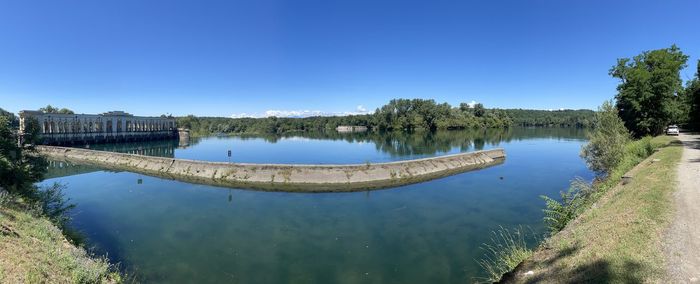 Scenic view of lake against clear blue sky