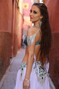 Portrait of beautiful young woman standing outdoors