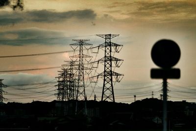 Low angle view of electricity pylon against sky