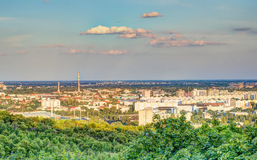 View of cityscape against cloudy sky