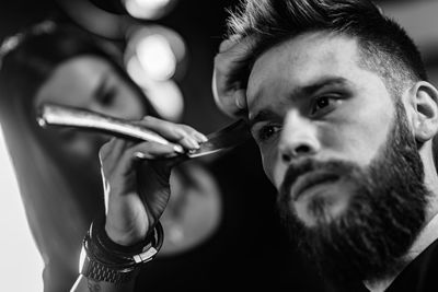 Portrait of young man holding camera