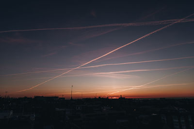 Silhouette cityscape against sky during sunset