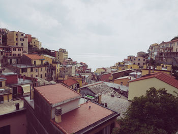 High angle view of houses in town against sky