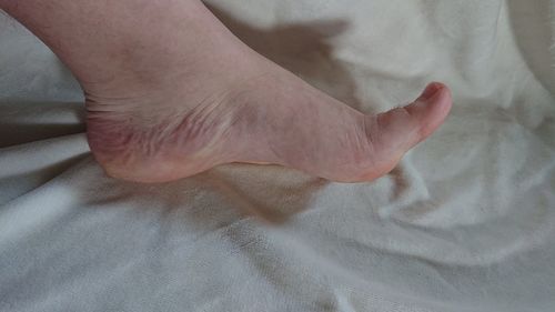 Low section of person legs on bed