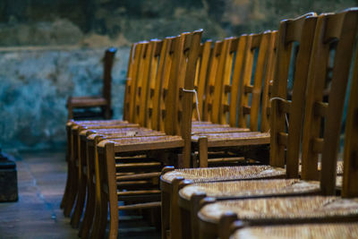 Empty chairs and tables in row