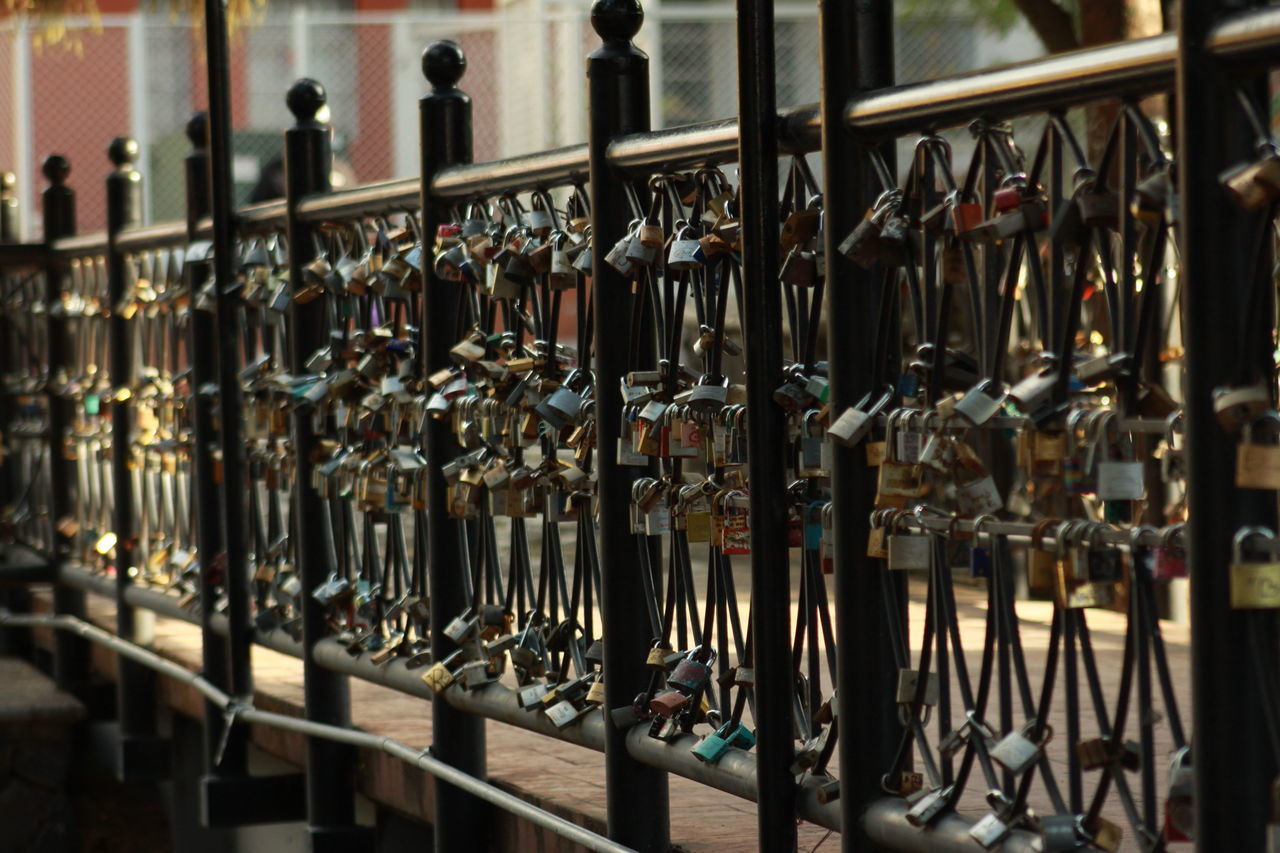 CLOSE-UP OF BOTTLES HANGING IN SHELF