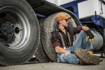 Portrait of senior mechanic repairing car