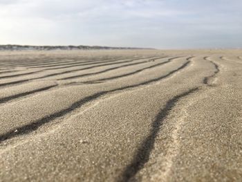 Sand dunes in desert against sky