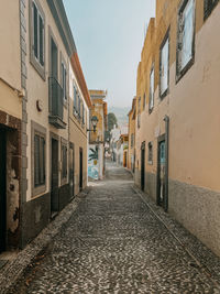 Narrow alley amidst buildings in city