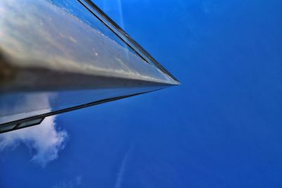 Low angle view of modern building against blue sky