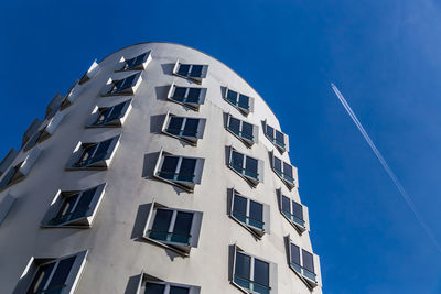 Low angle view of modern building against clear blue sky