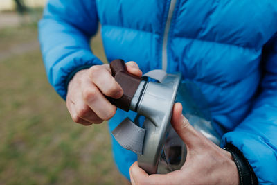 Midsection of man holding camera