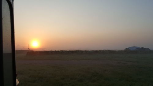 Scenic view of field against sky during sunset