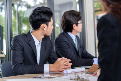 Business people working at table in office