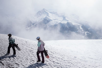 Rear view of man on snow covered mountain