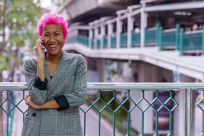 Portrait of smiling woman standing outdoors