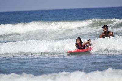 People surfing in sea