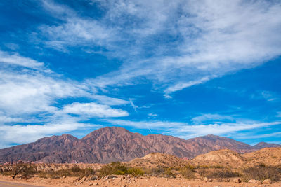 View of desert against cloudy sky