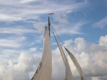 Low angle view of sailing ship against sky