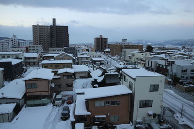 High angle view of buildings in city against sky